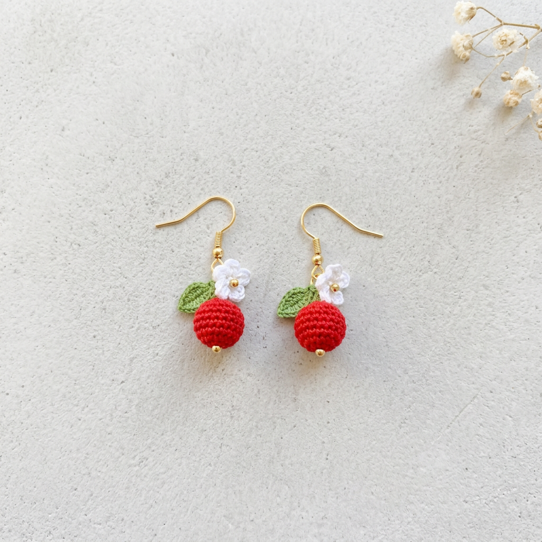 Micro Crochet Berry Earrings flat lay with dried flowers