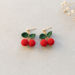 Micro Crochet Cherry Earrings flat lay with dried flowers