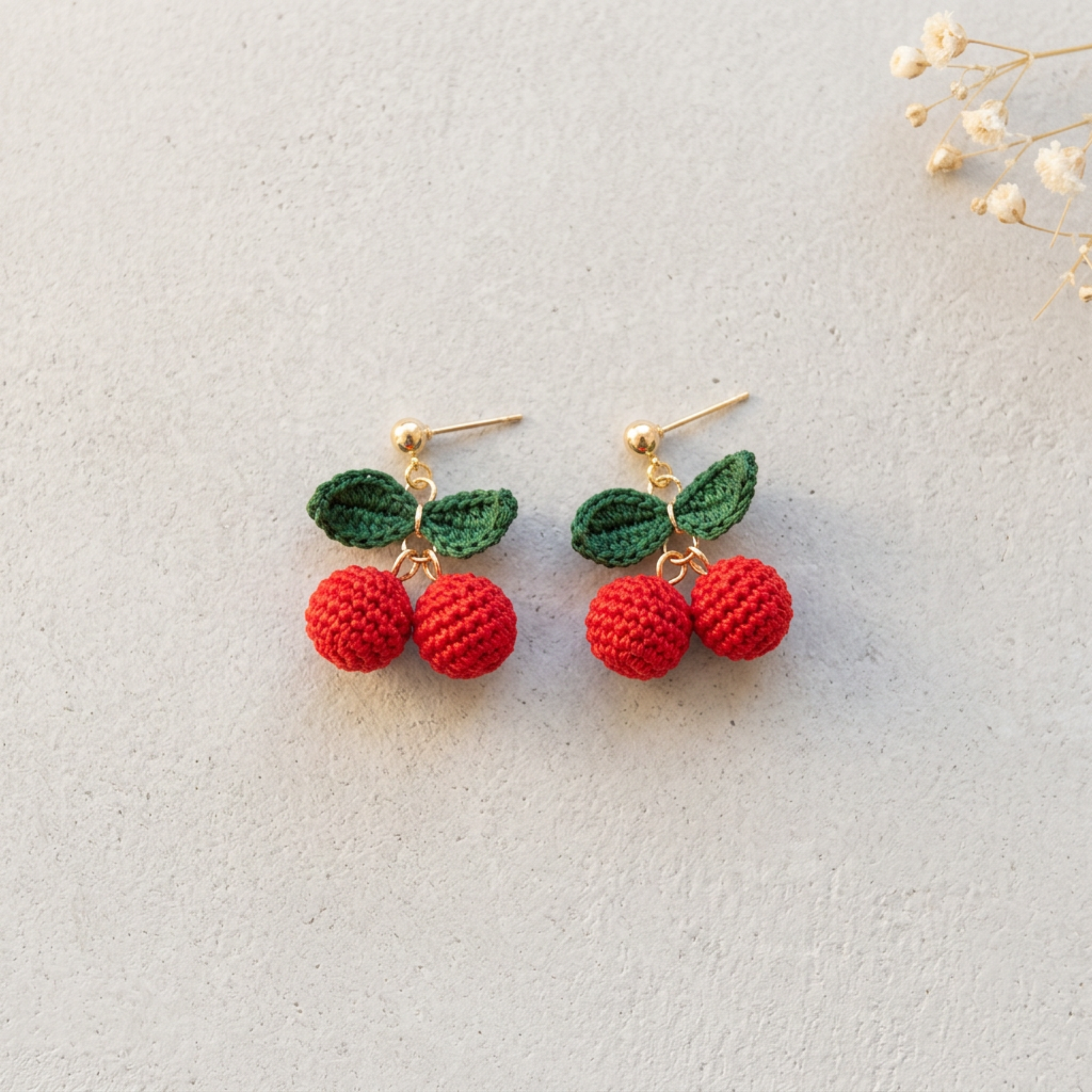 Micro Crochet Cherry Earrings flat lay with dried flowers