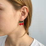 Woman wearing micro crochet cherry earrings