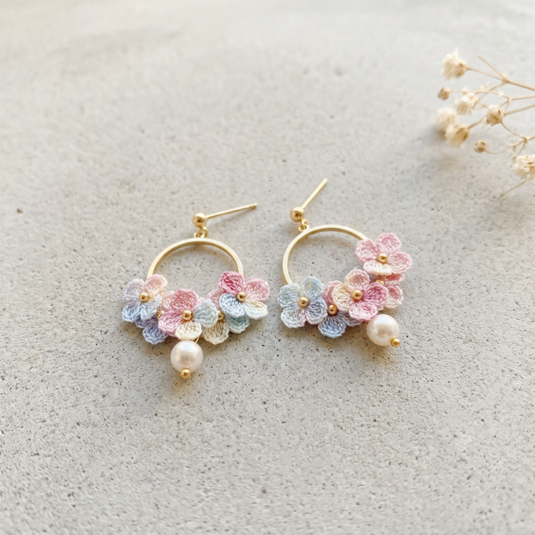 Micro Crochet Hydrangea Hoop Earrings hanging from natural branch