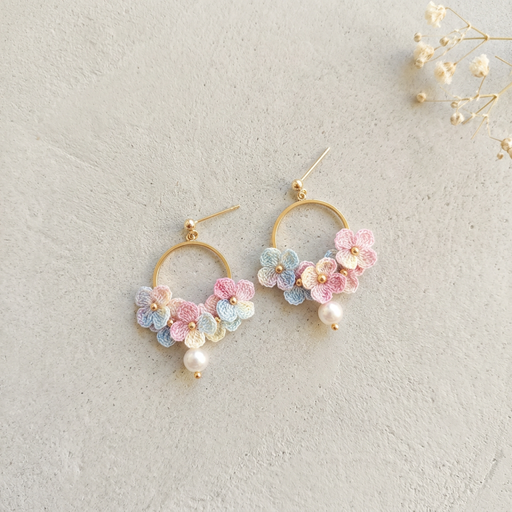 Micro Crochet Hydrangea Hoop Earrings flat lay with dried flowers