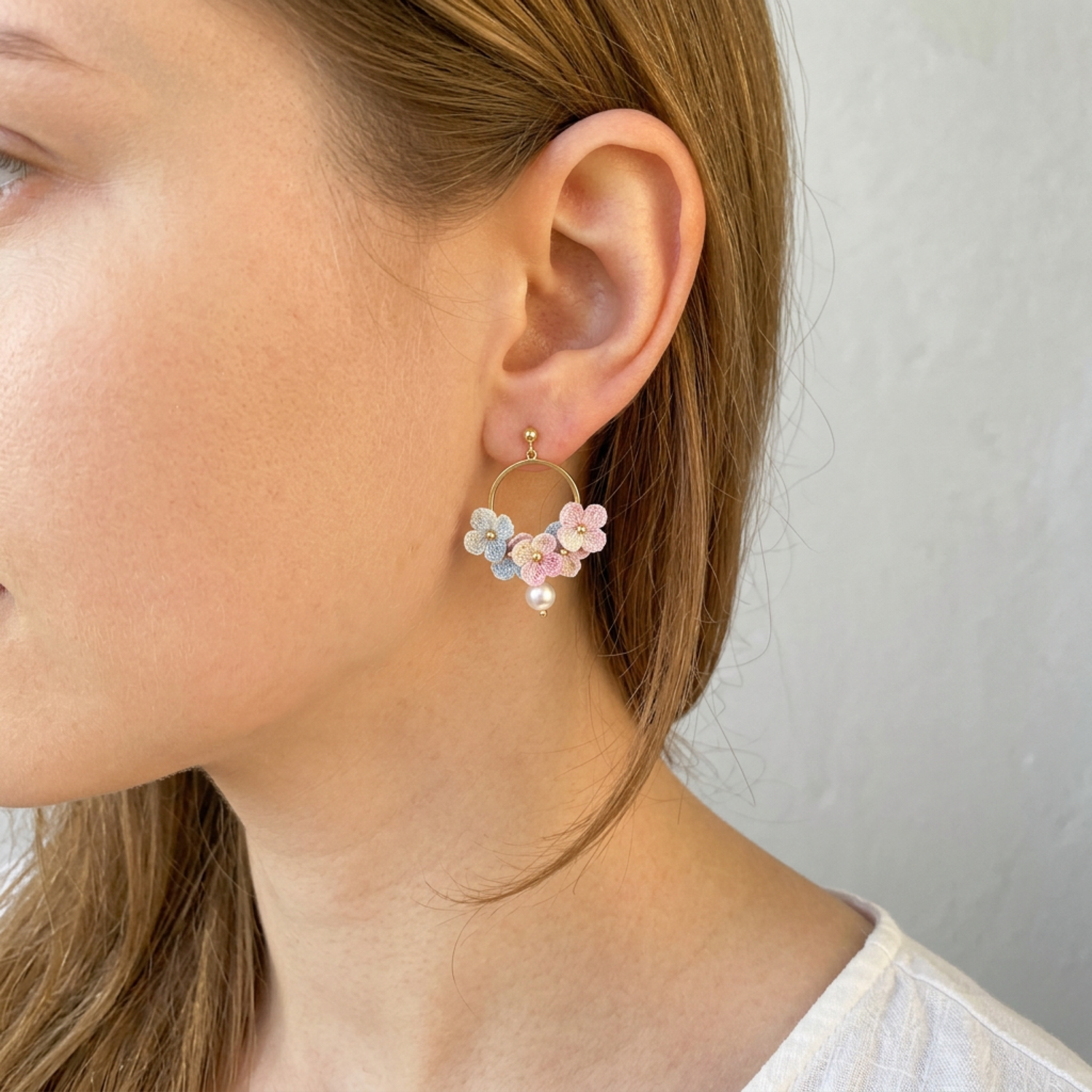 Woman wearing micro crochet hydrangea hoop earrings