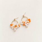 Orange cream micro crochet hydrangea hoop earrings with pearl drops, pair on ivory background