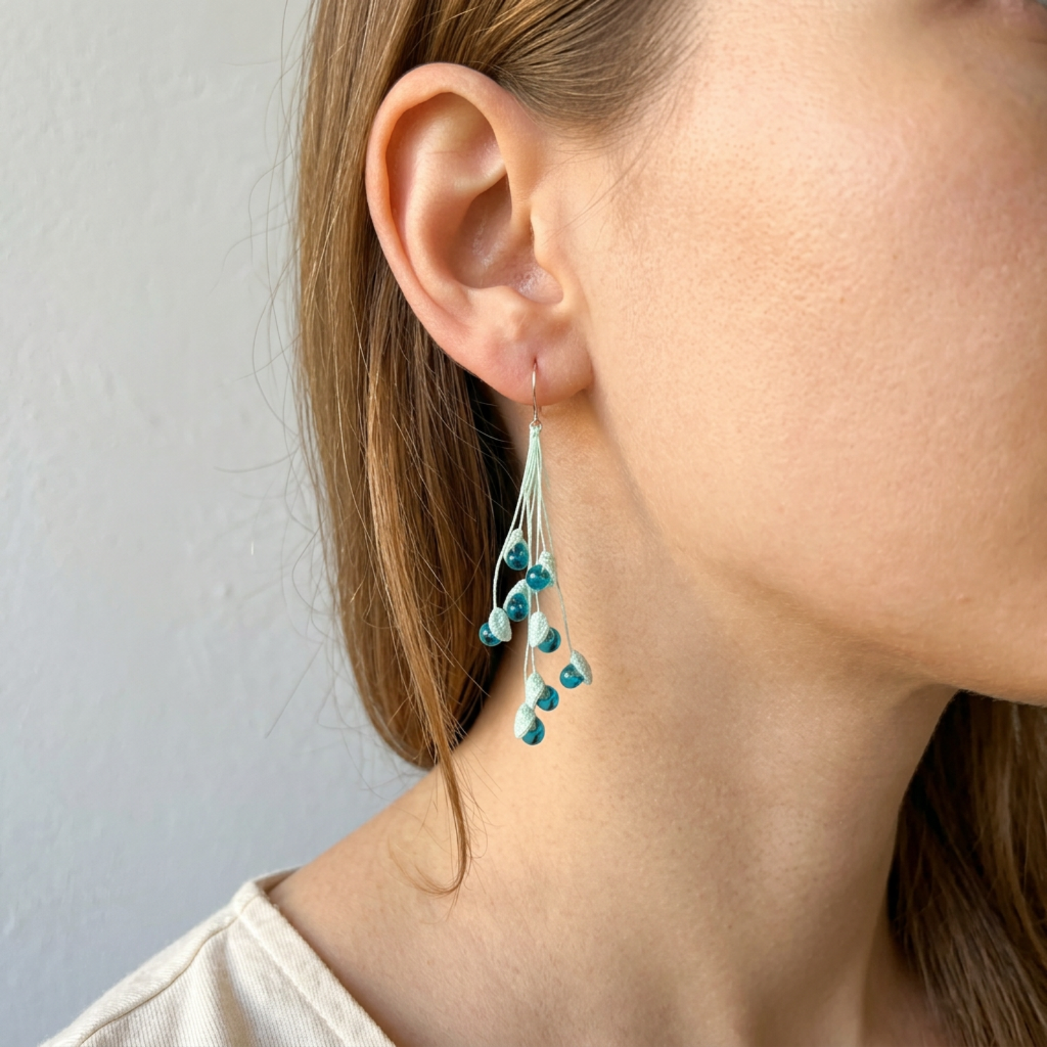 Woman wearing micro crochet lily of the valley earrings