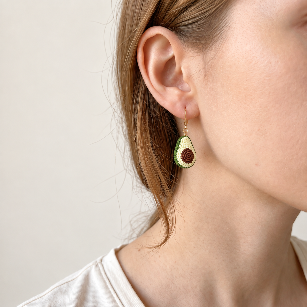 Micro crochet avocado earrings — close-up wearing view