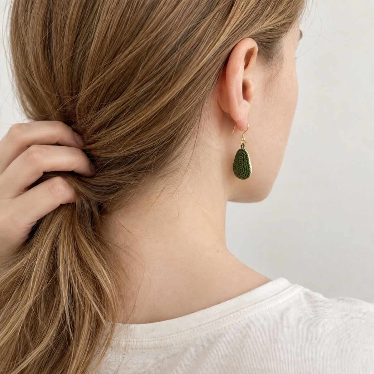 Micro crochet avocado earrings — rear wearing view