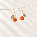 Petalore Orange berry micro crochet earrings — pair on an ivory display 