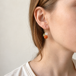 Petalore Orange berry micro crochet earrings — close-up wearing view 