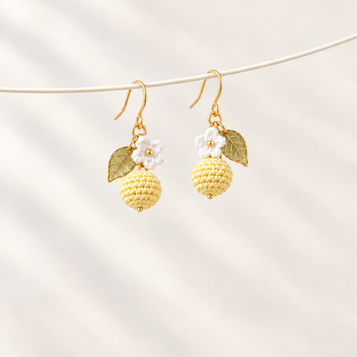Petalore Lemon Yellow berry micro crochet earrings — pair on an ivory display 