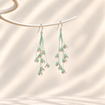 Petalore Pink lily of the valley micro crochet earrings — pair on an ivory display 