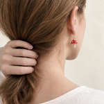 Petalore red mushroom micro crochet earrings — rear wearing view