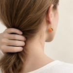 Micro crochet tangerine earrings — rear wearing view
