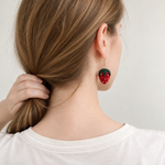 Micro crochet strawberry earrings — rear wearing view
