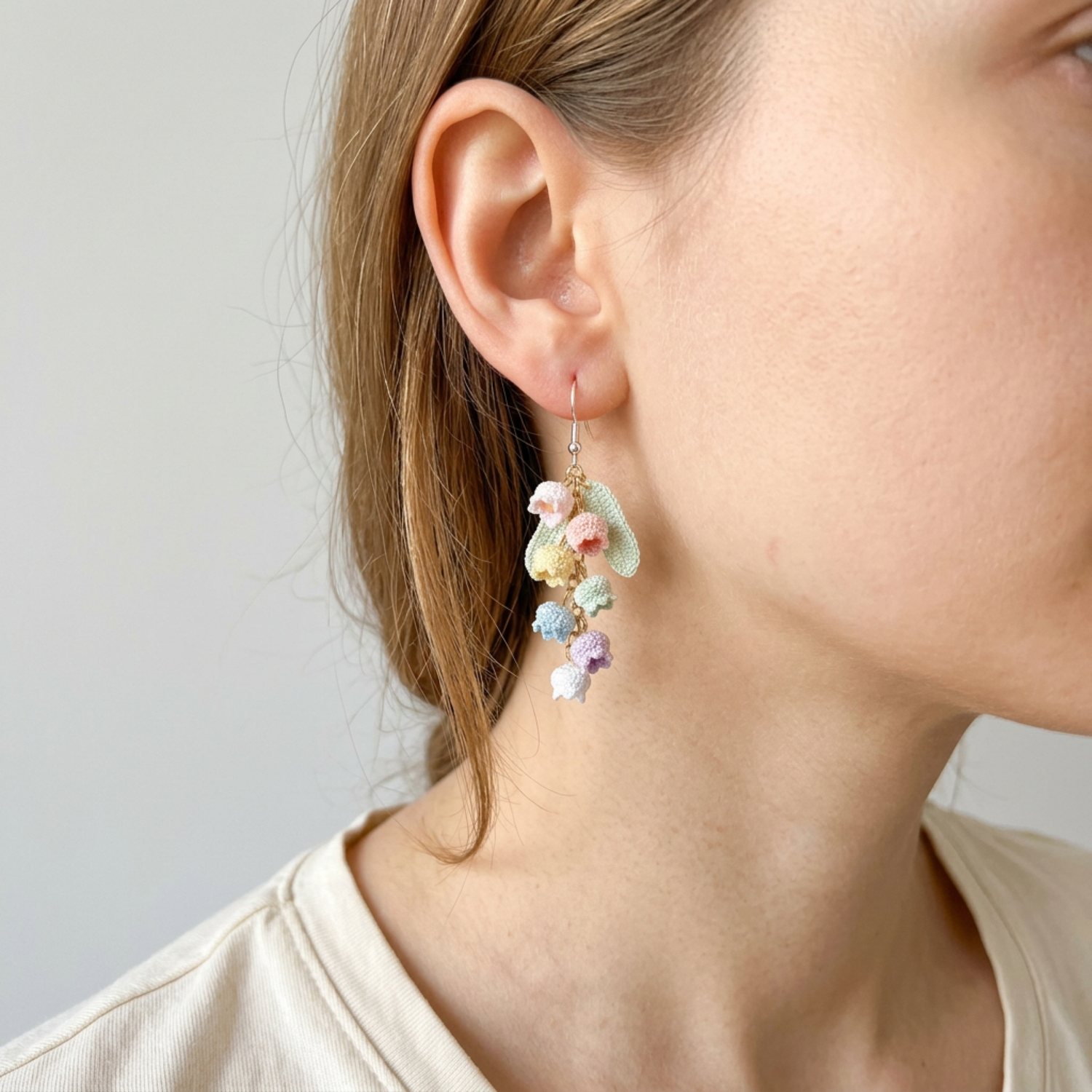 Woman wearing micro crochet rainbow bell flower earrings