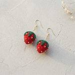 Micro Crochet Strawberry Earrings flat lay with dried flowers