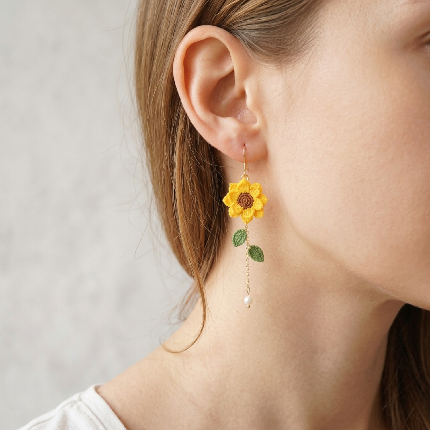 Woman wearing micro crochet sunflower dangle earrings