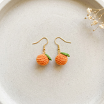 Micro Crochet Orange Earrings flat lay with dried flowers