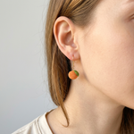 Woman wearing micro crochet orange earrings